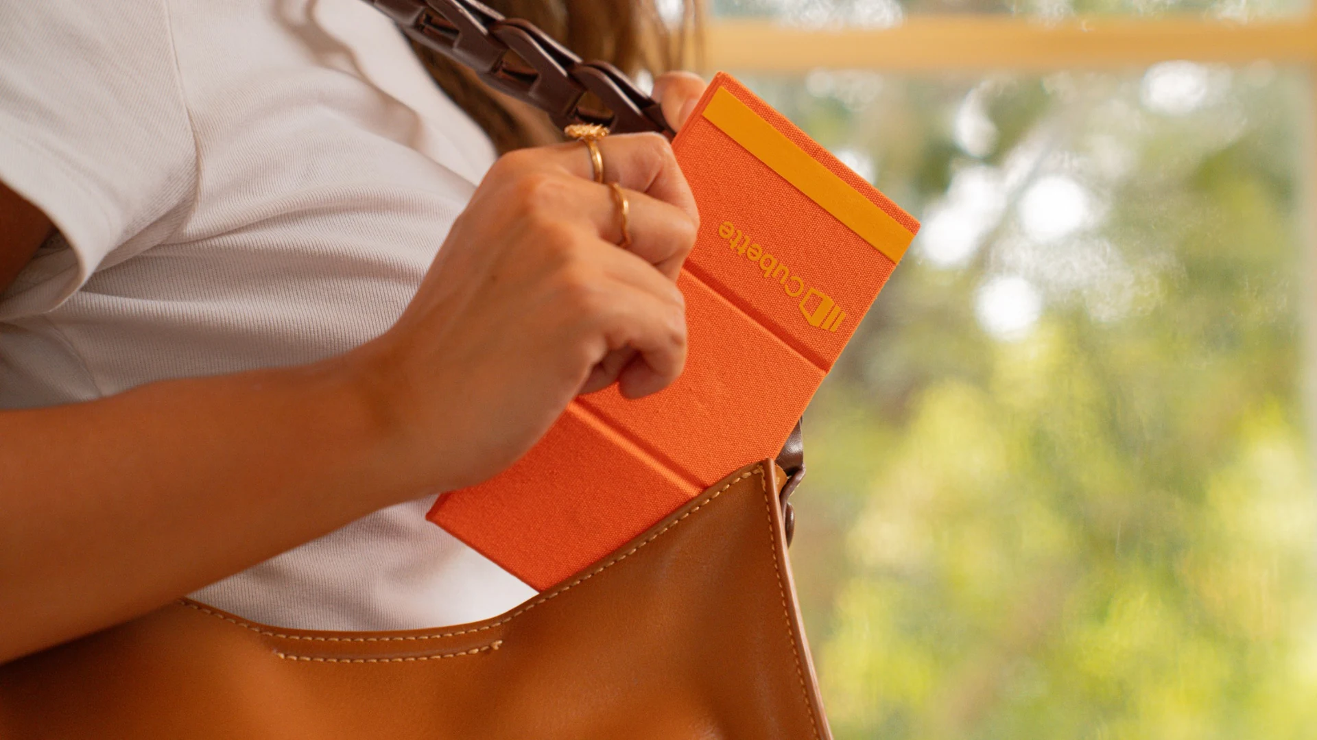Cubette fold-flat organizer slipping into a leather bag